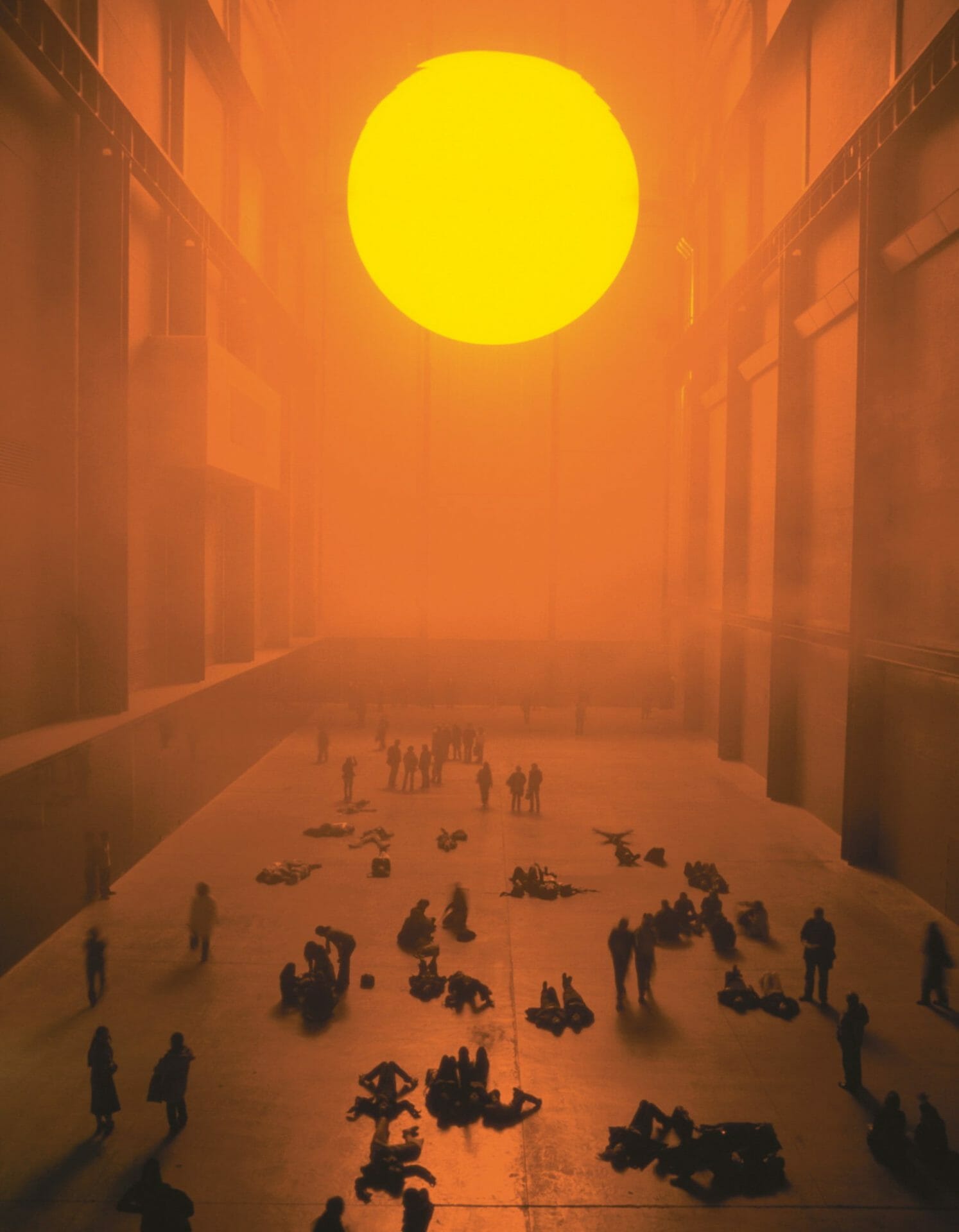 “The weather project” (2003), monofrequency lamps, projection screen, haze machines, foil mirror, aluminum, scaffolding, 26.7 x 22.3 x 155.44 meters, installation view at Tate Modern, London. Photo by Tate photography, Andrew Dunkley & Marcus Leith