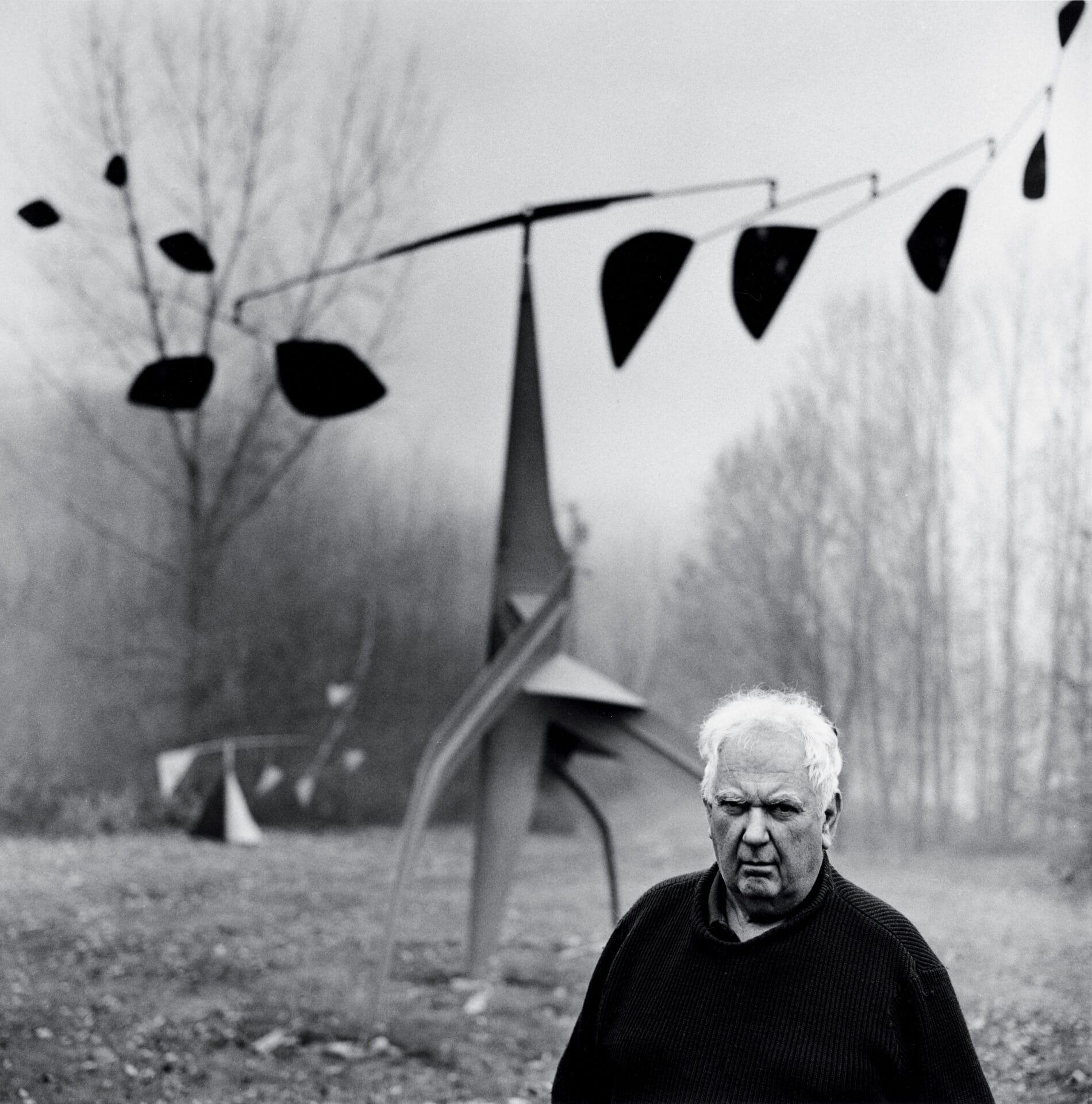 Calder with Southern Cross (1963) and Back from Rio (1959), Roxbury, c. 1963. Photograph by Herb Weitman © Herb Weitman, St. Louis. Gelatin silver print, 14" x 11". Photo courtesy of Calder Foundation, New York / Art Resource, New York.