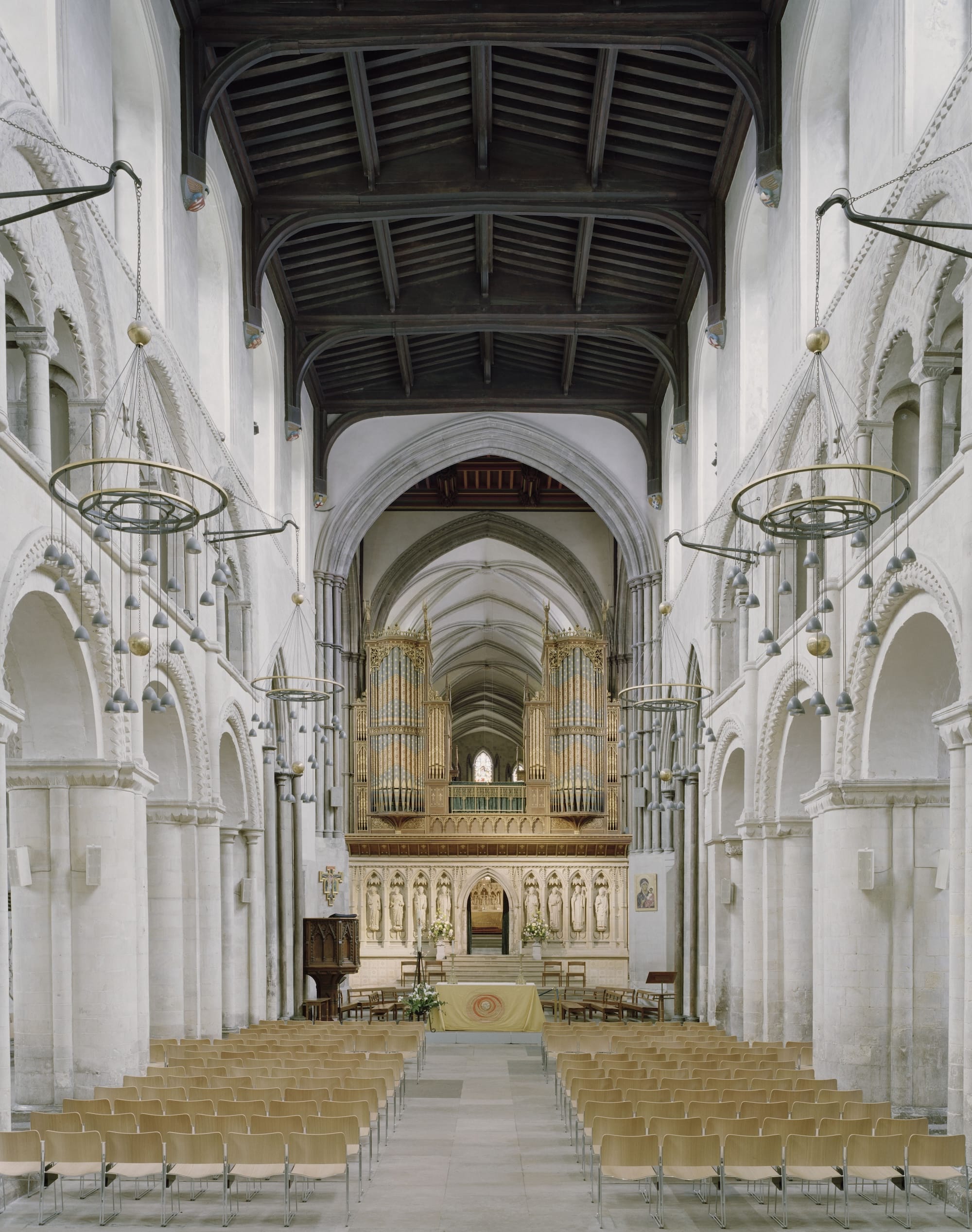 Het schip van Rochester Cathedral met een houten plafond, stenen bogen en een groot orgel boven het altaar